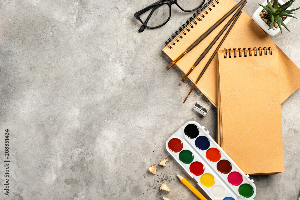 Workplace composition with paint and notebook on table, flat lay