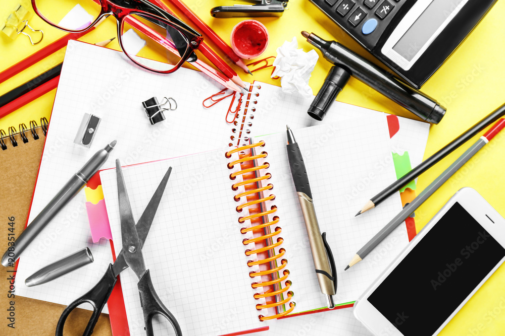 Workplace composition with smartphone, notebooks and stationery on table, flat lay