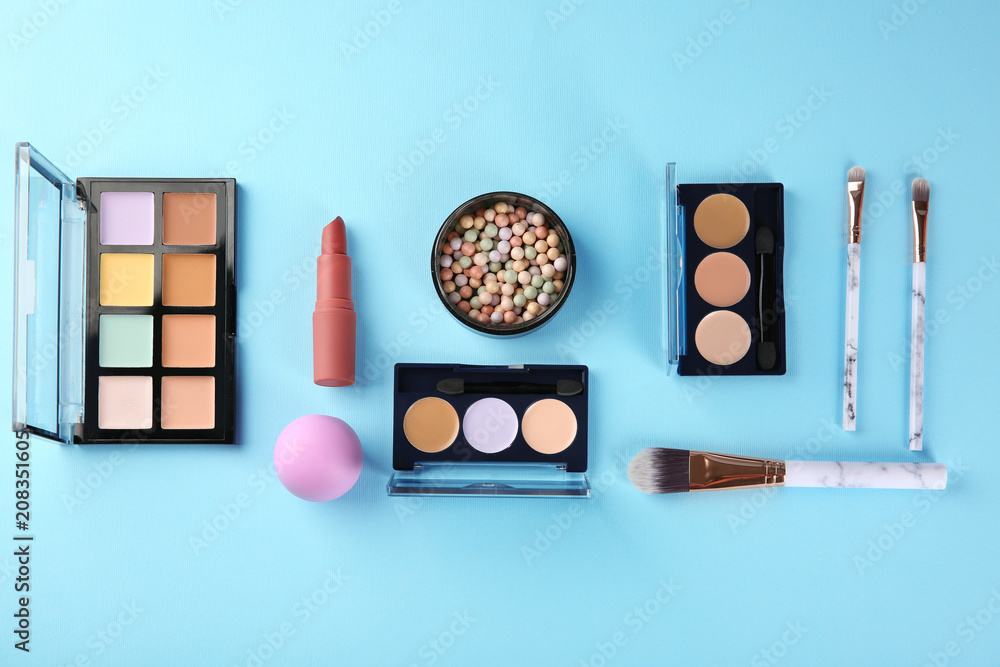 Flat lay composition with professional cosmetics on color background