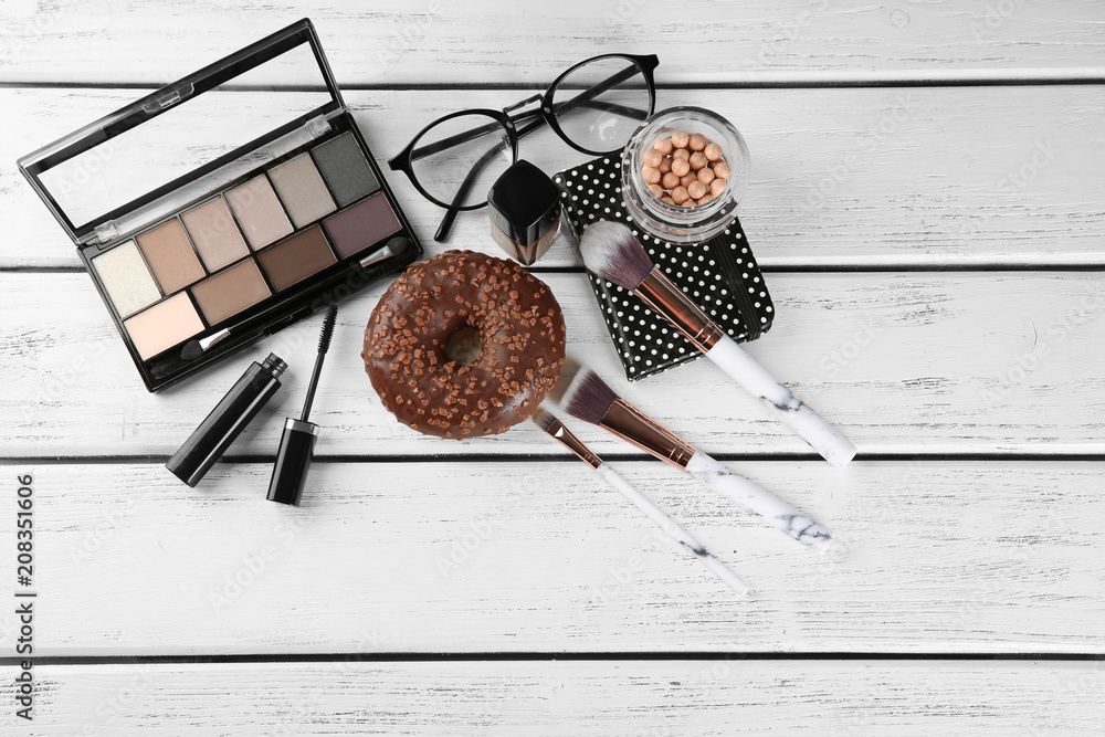 Flat lay composition with professional cosmetics on wooden background