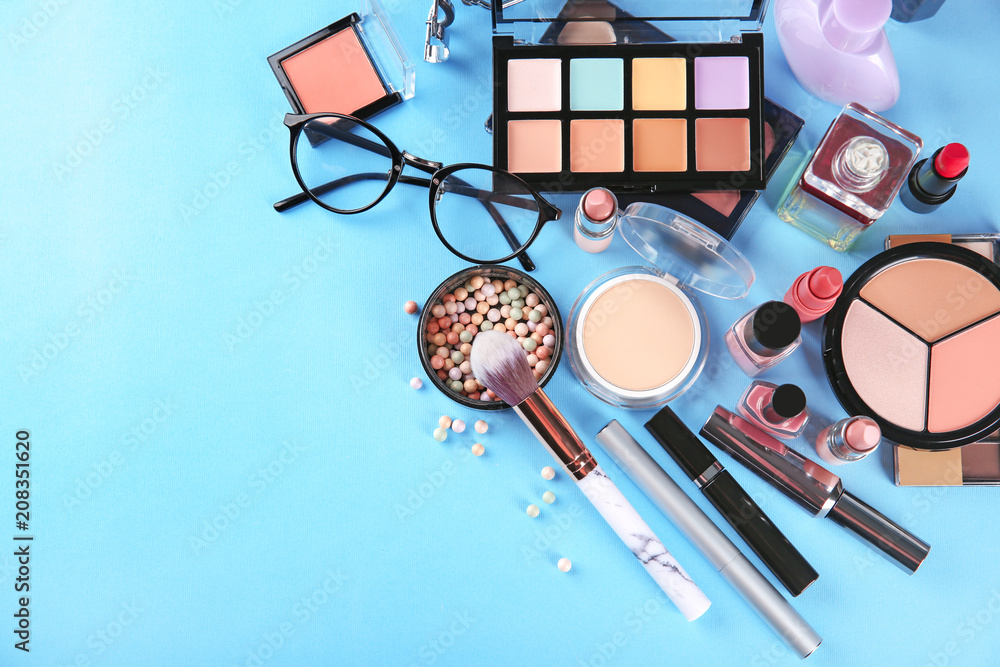 Flat lay composition with professional cosmetics on color background