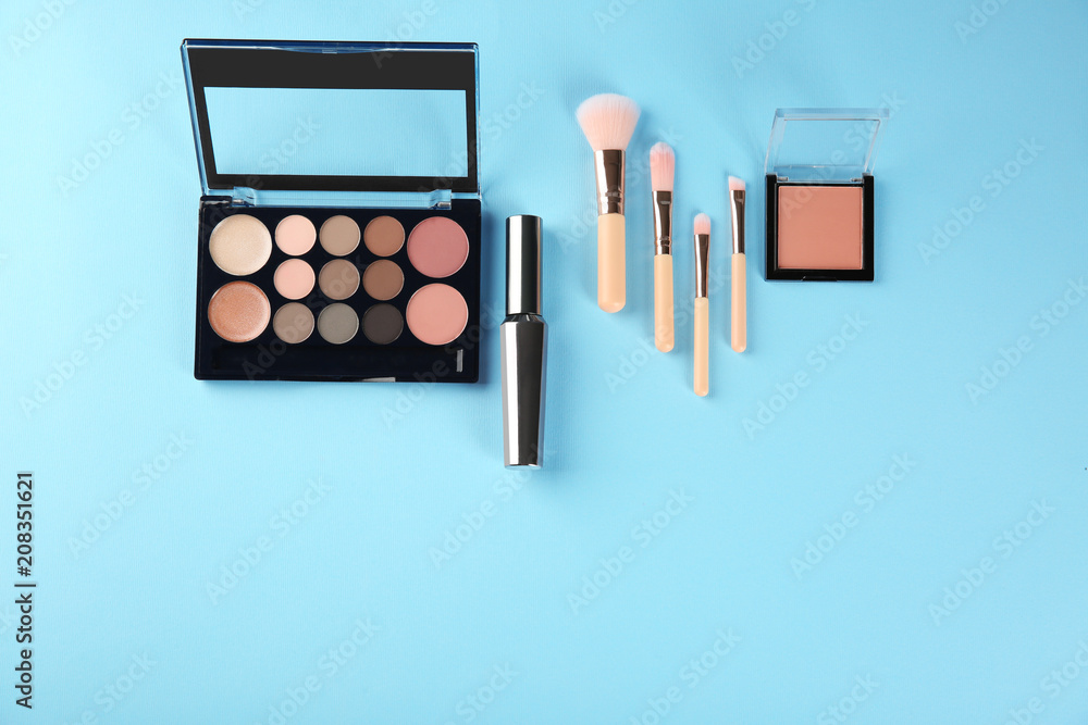 Flat lay composition with professional cosmetics on color background