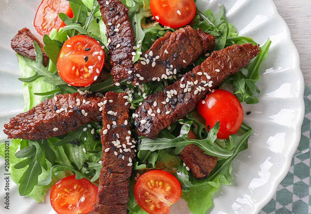 Tasty salad with meat and cherry tomatoes on plate