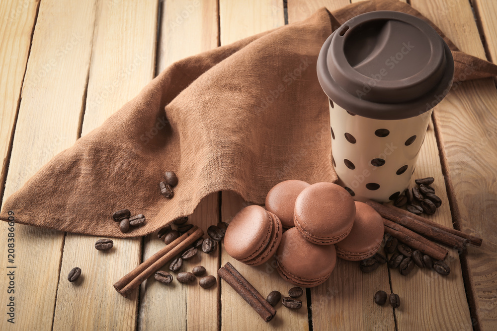 Composition with chocolate macarons on wooden background