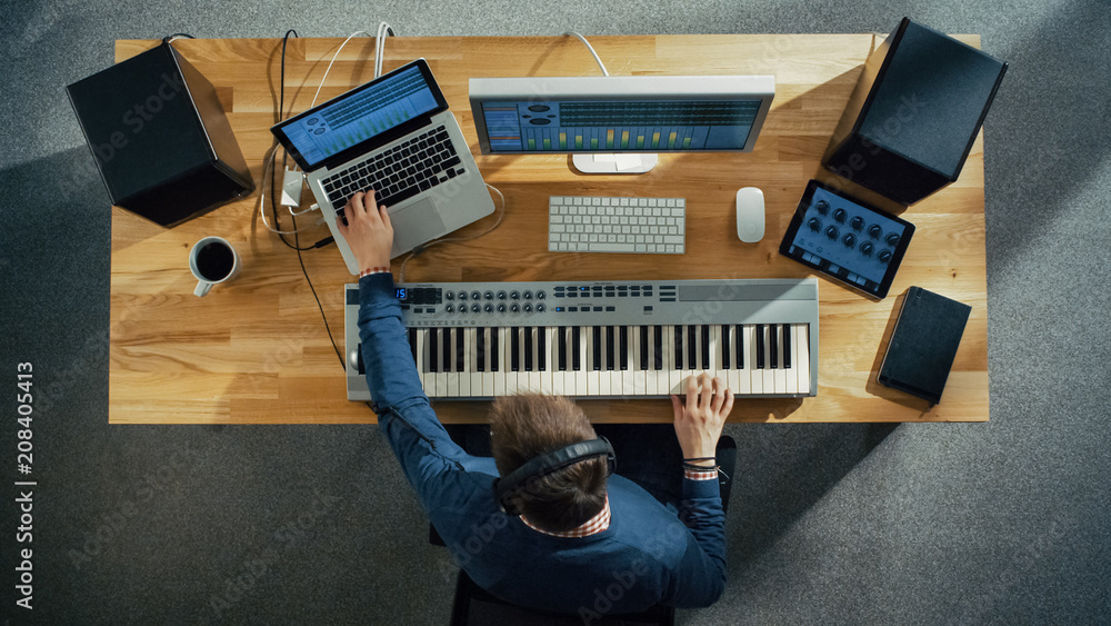 Top View of a Musician Creating Music at His Studio, Playing on a Musical Keyboard. His Studio is Su