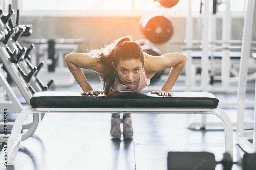 woman pushup with focus and concentration in gym healthy ideas concept