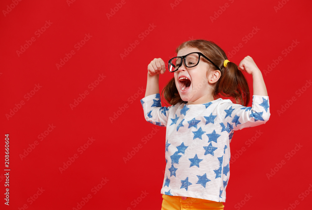 funny child girl in glasses on colored background