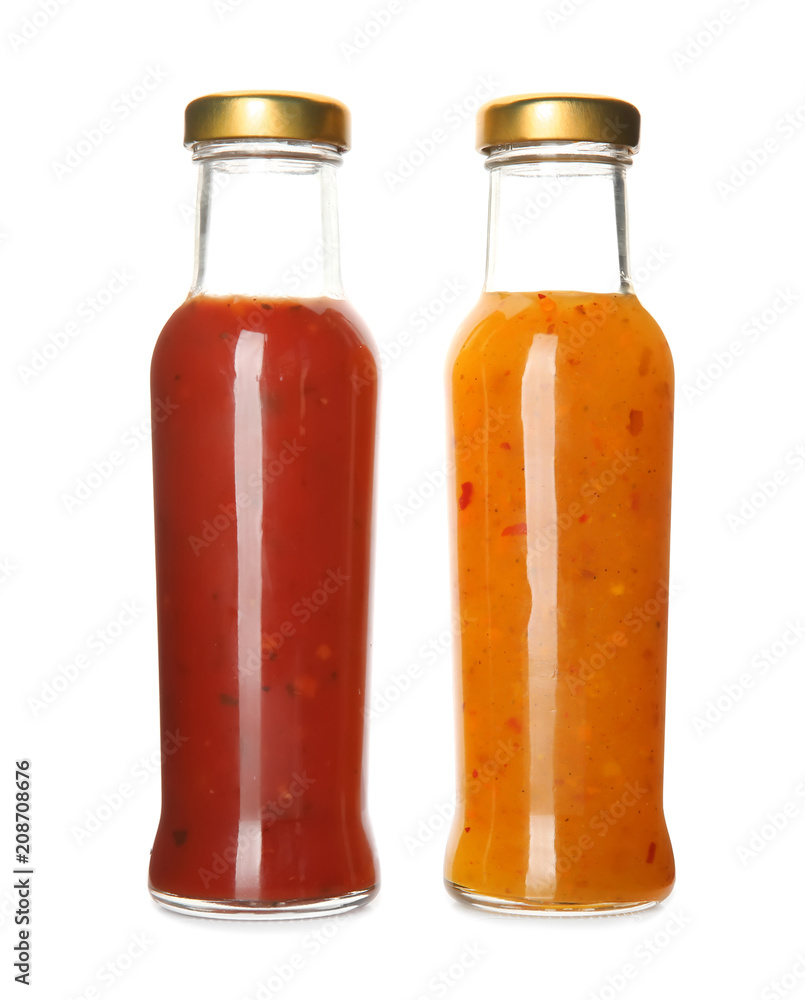 Bottles with tasty sauces on white background