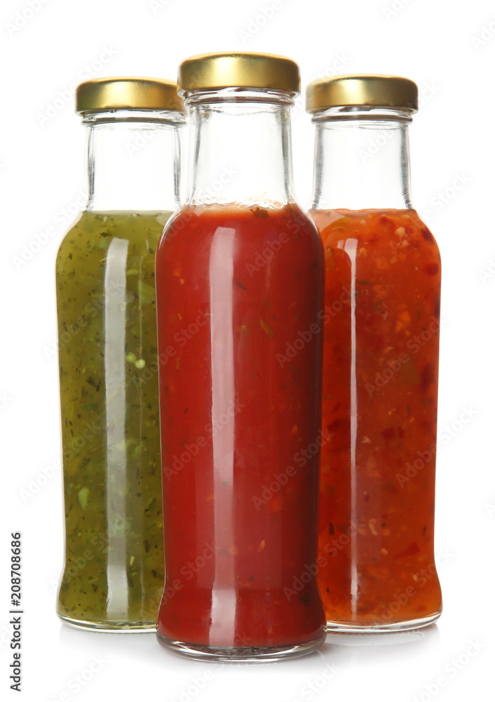 Bottles with tasty sauces on white background