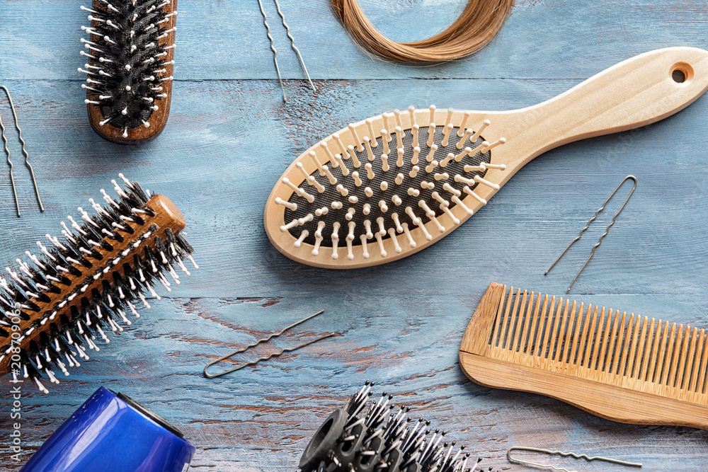 Flat lay composition with set of hairdressers tools on wooden background