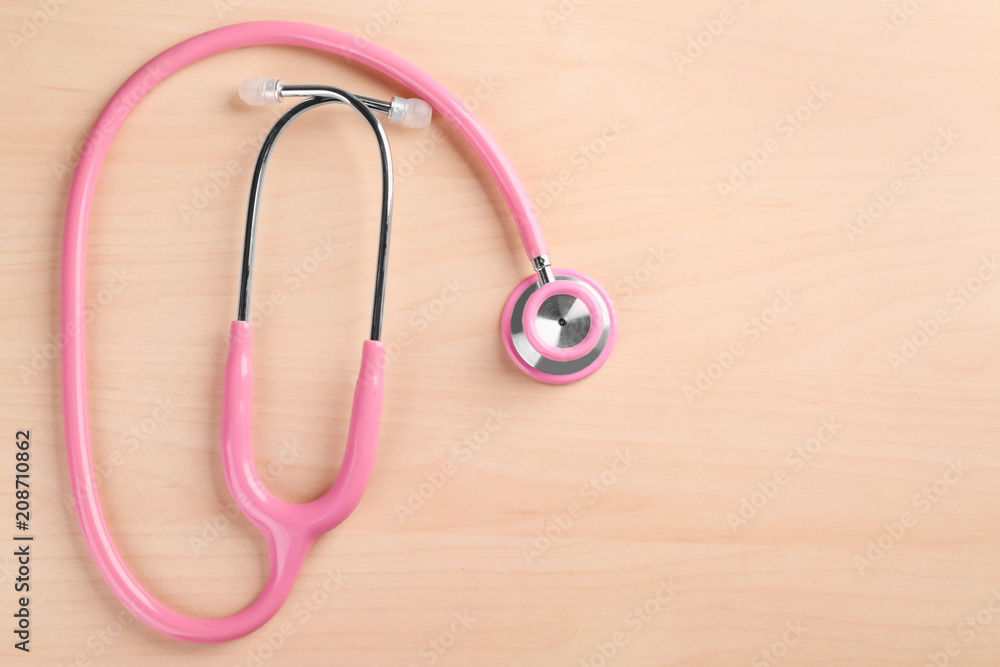 Stethoscope on light wooden background