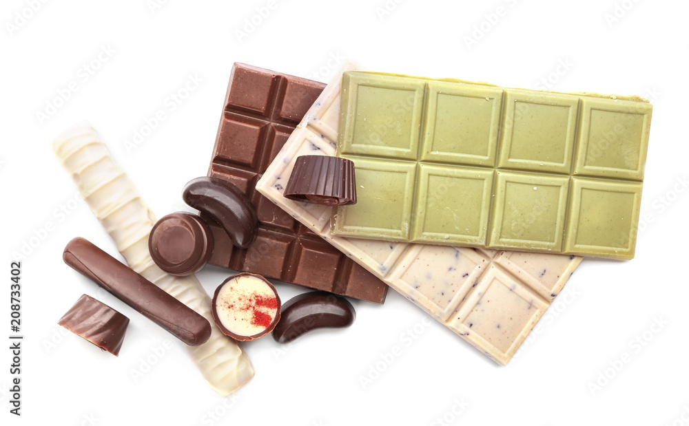 Different chocolate bars and candies on white background