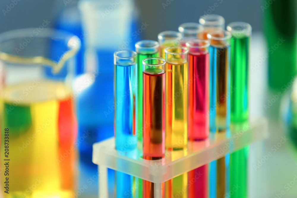 Test tubes with colorful samples in laboratory, closeup