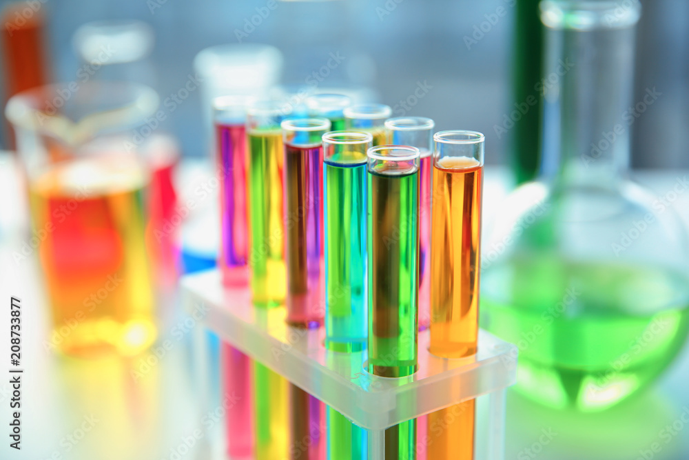 Test tubes with colorful samples in laboratory, closeup