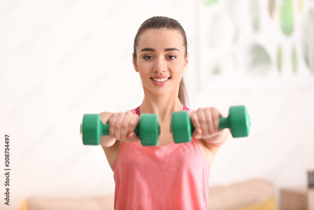 Beautiful young woman doing exercises in morning