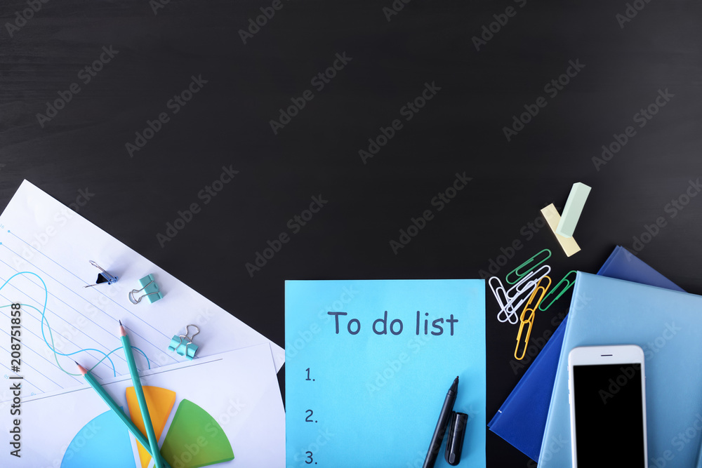 Composition with stationery and empty to do list on black background