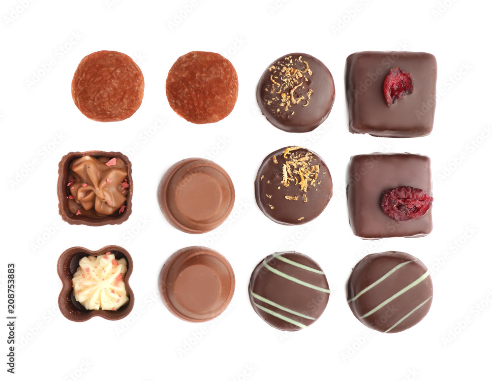 Tasty chocolate candies on white background, flat lay