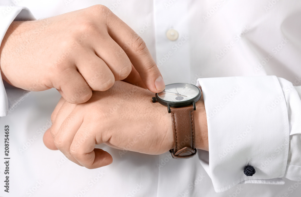 Man looking at his watch, closeup. Time management concept