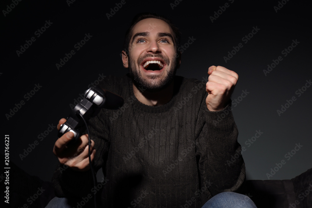 Young man playing video games at home