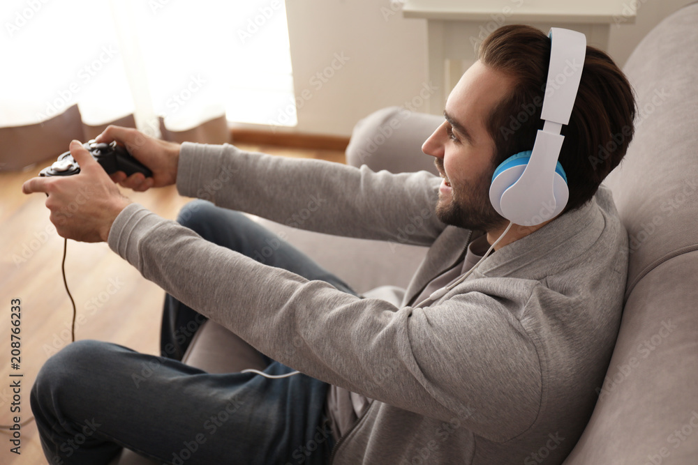 Young man playing video games at home