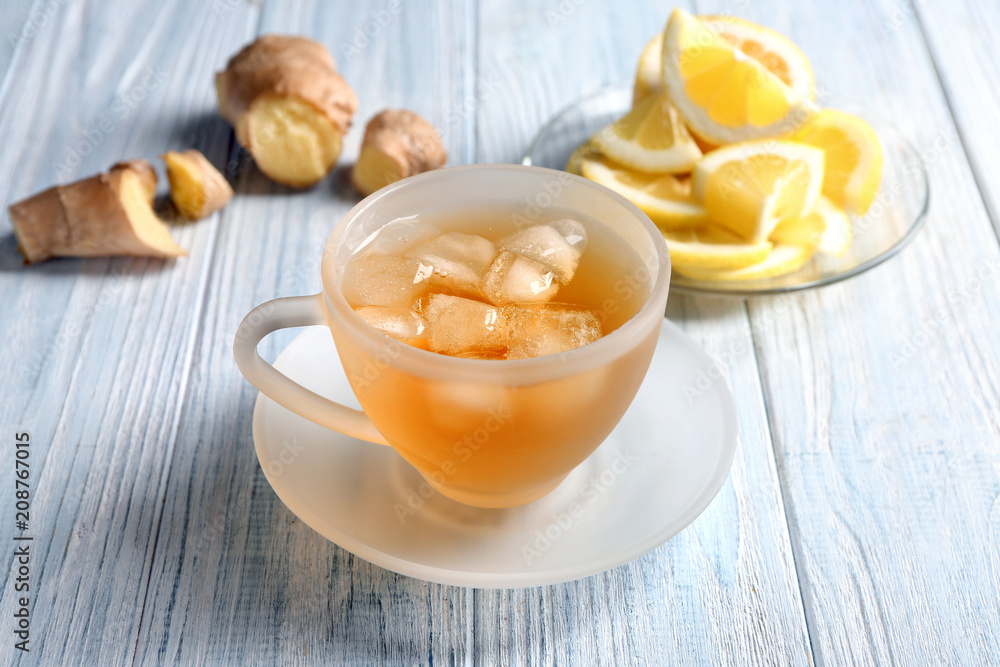 Cup of delicious tea with ice on table