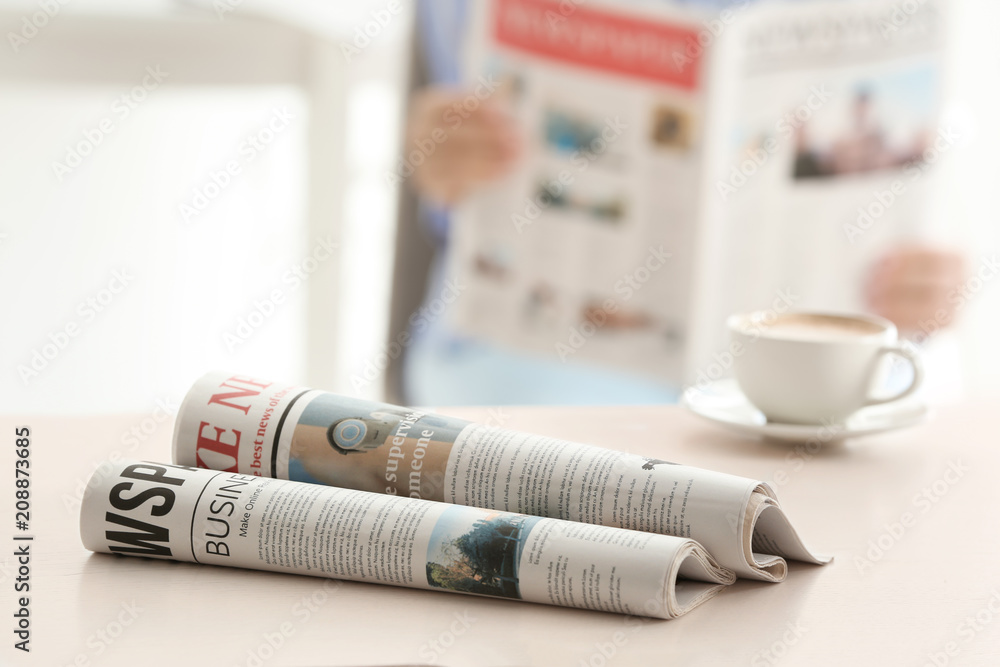 Morning newspapers on white table