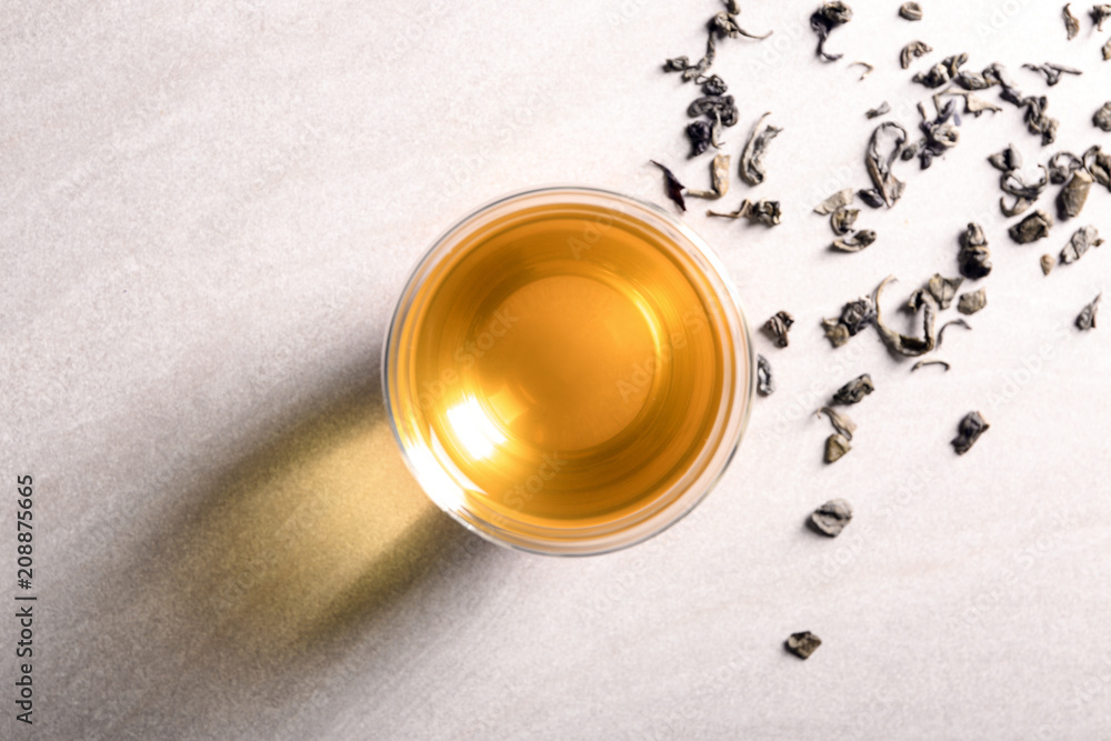 Glass with delicious green tea on light background, top view