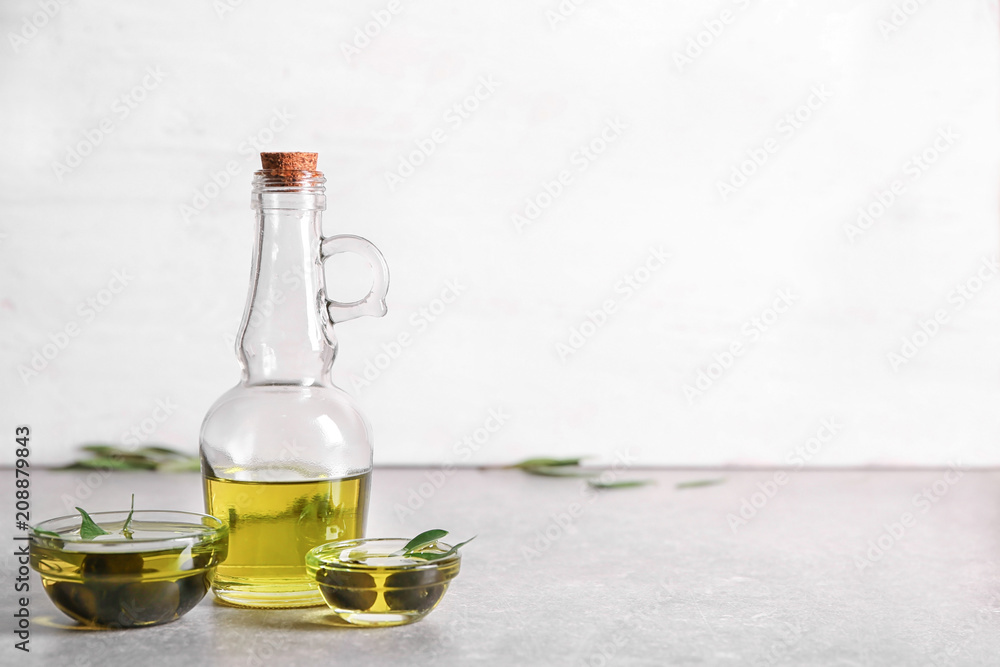 Glassware with oil and canned olives on table