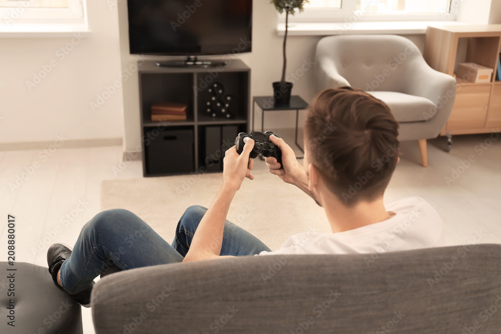 Man playing video game at home