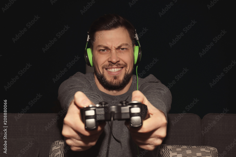 Emotional man playing video game at home