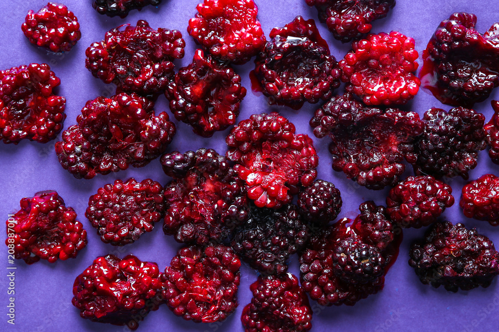 Smashed blackberries on color background