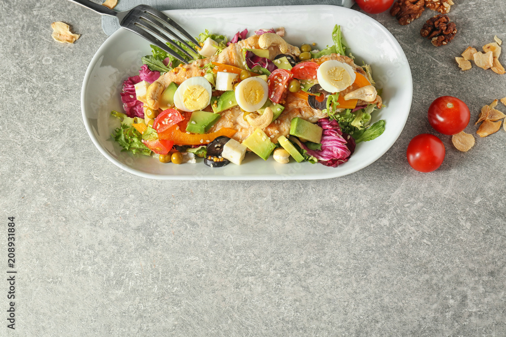 Plate of tasty salad with ripe avocado on table