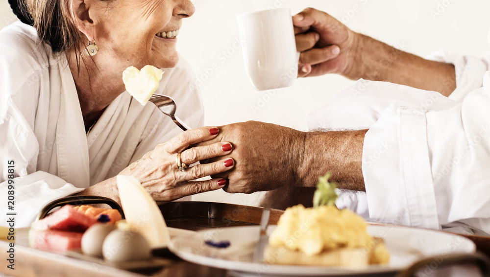 Couple having breakfast in bed