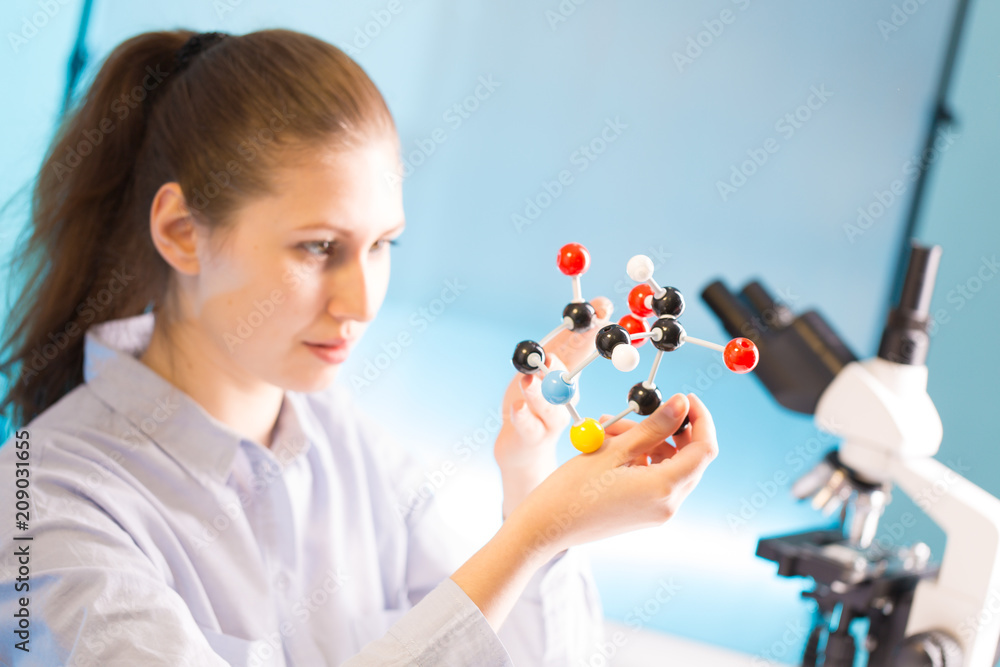 scientist woman holding molecule model