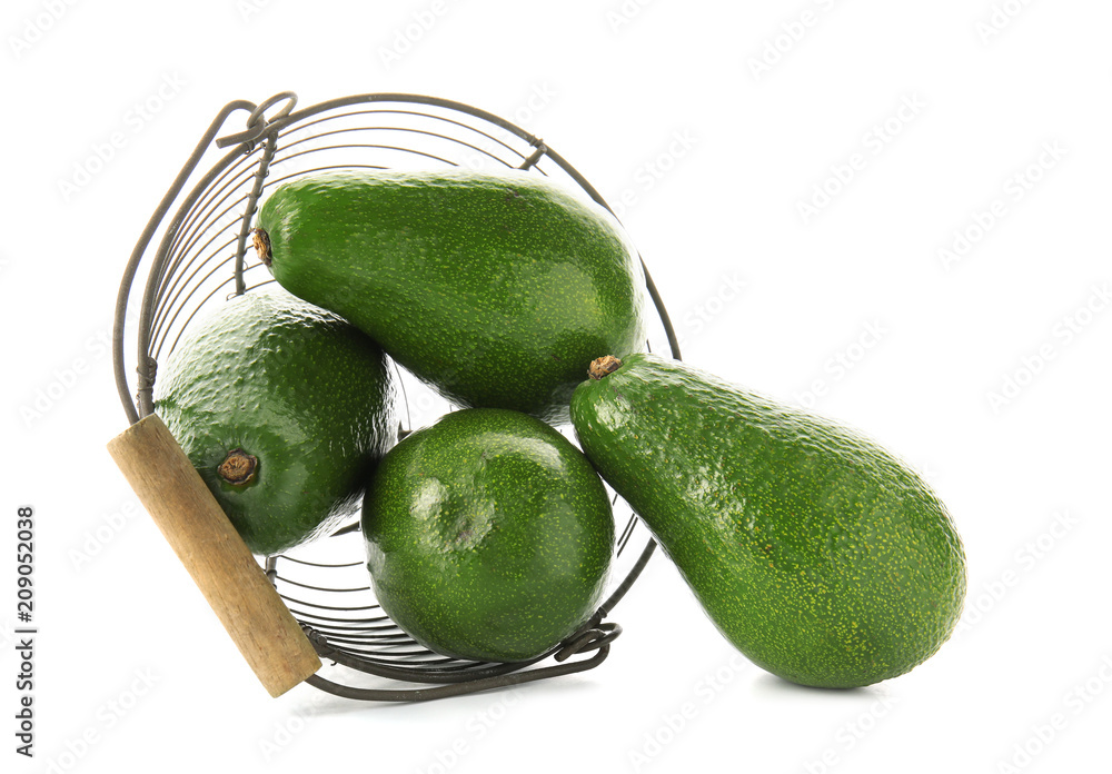 Metal basket with fresh avocados on white background