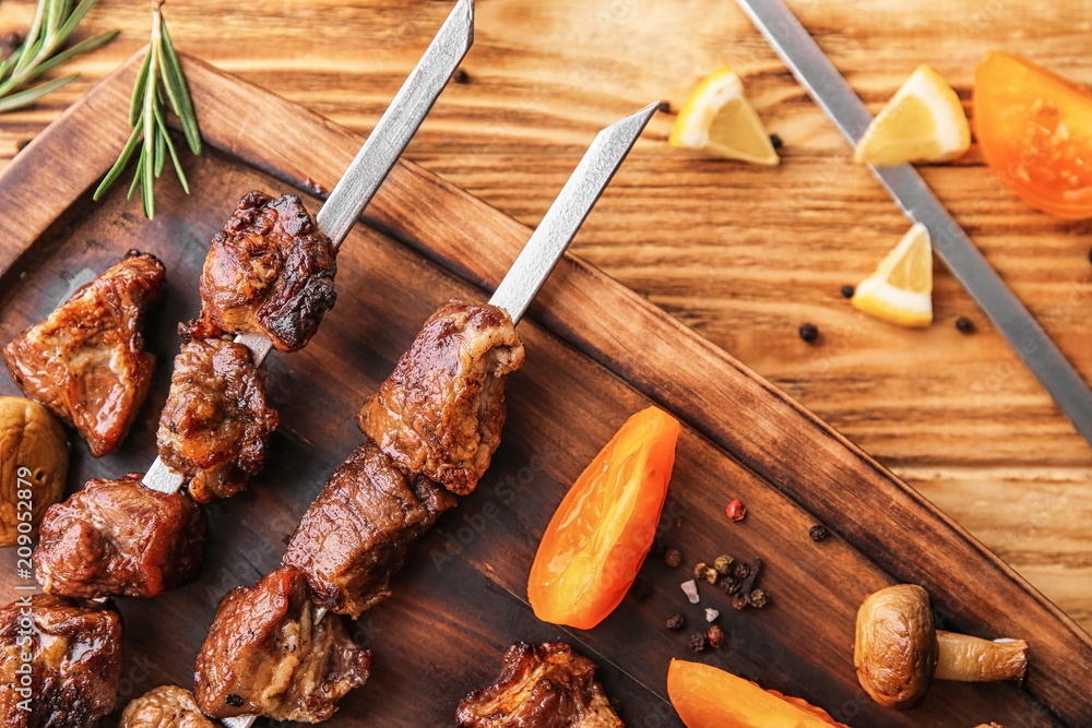 Pieces of shish-kebab on wooden board