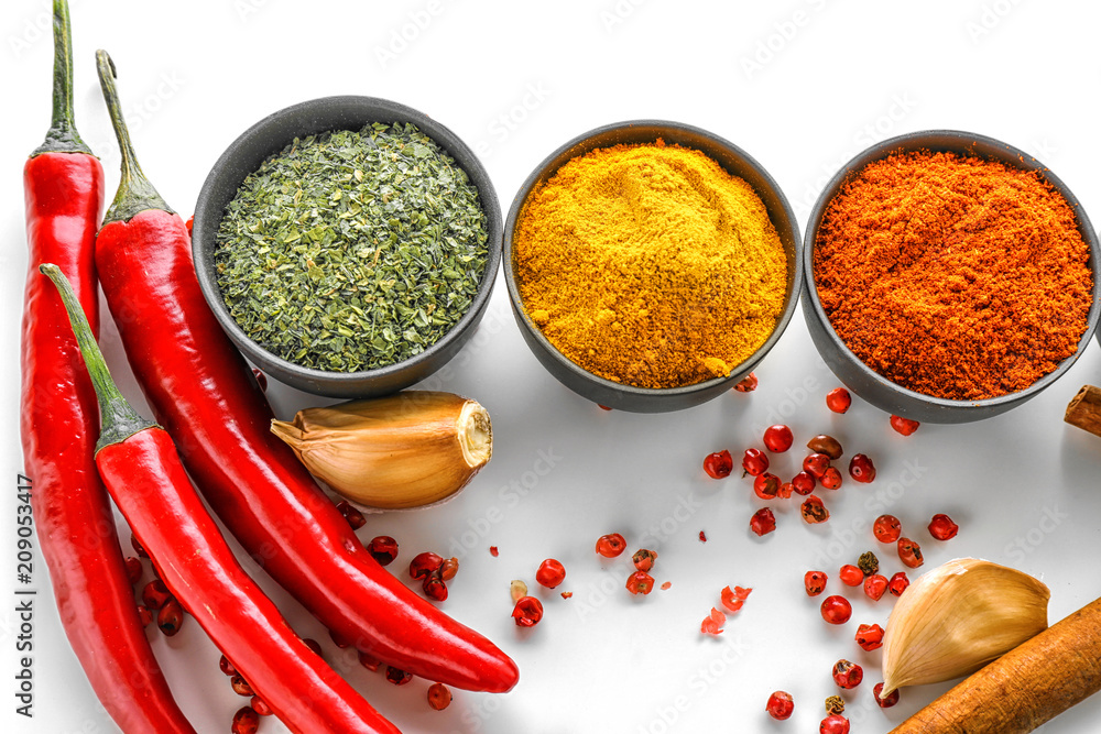 Bowls with various spices on white background