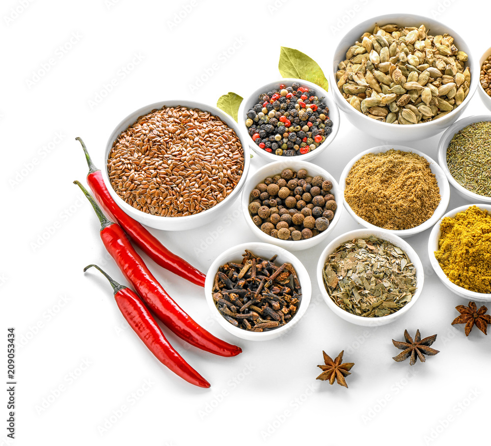 Bowls with various spices on white background