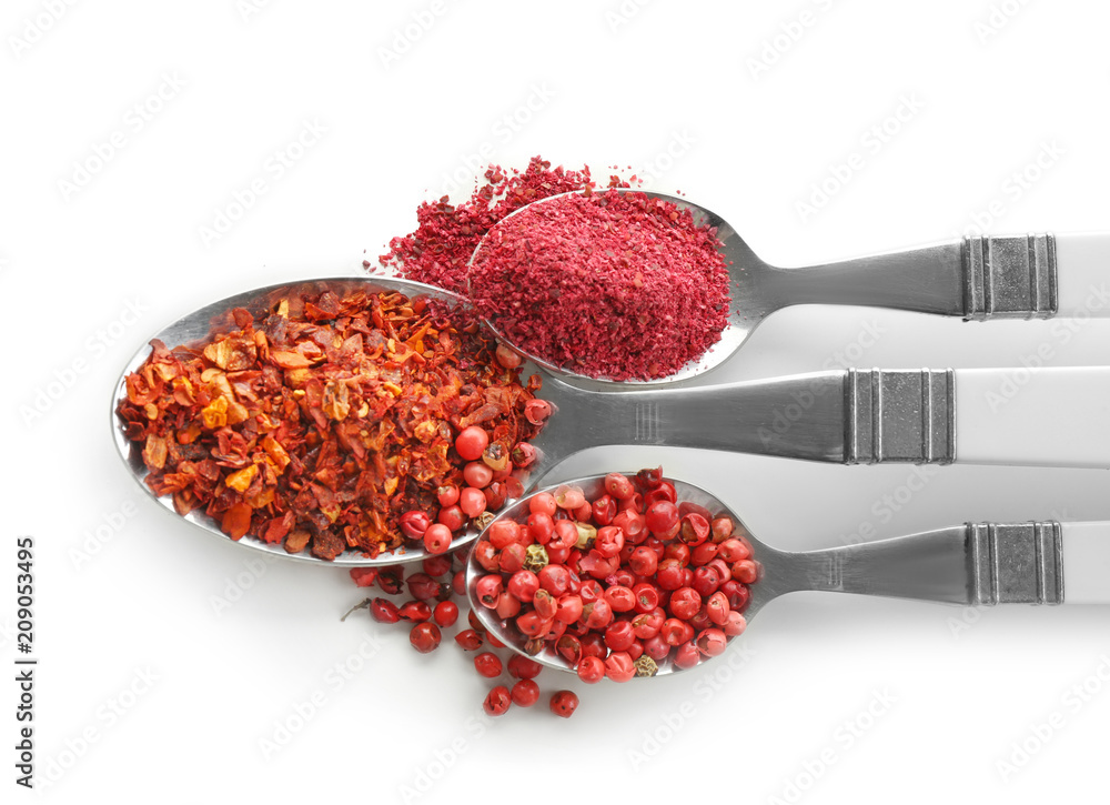 Spoons with various spices on white background