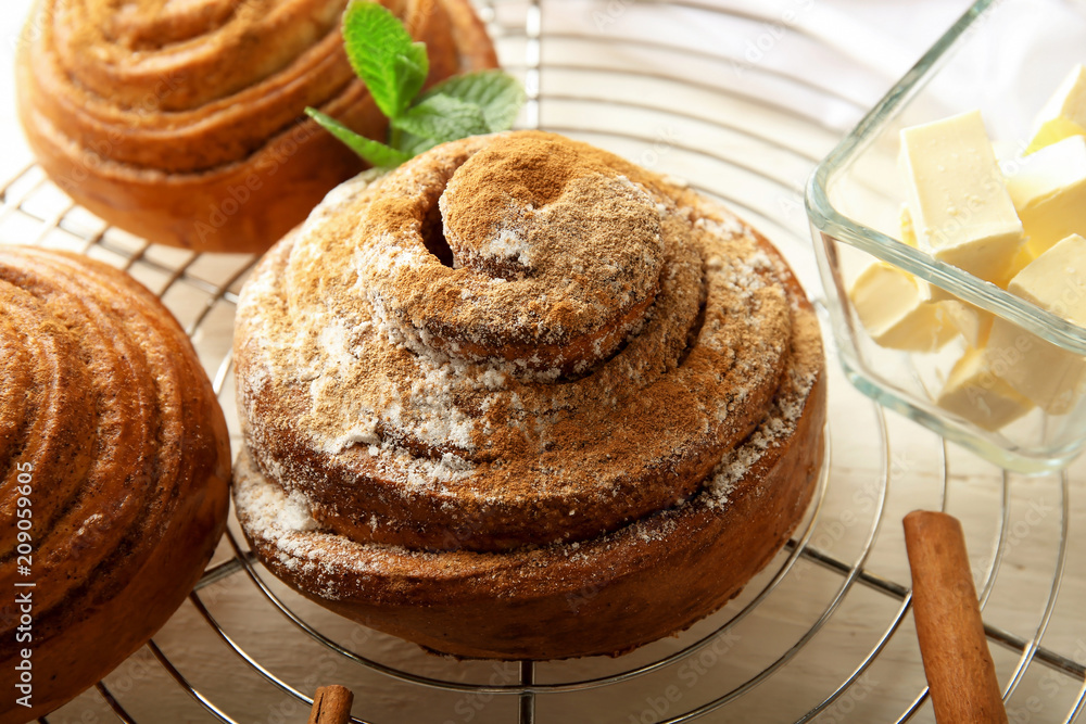 Sweet cinnamon buns on cooling rack, closeup