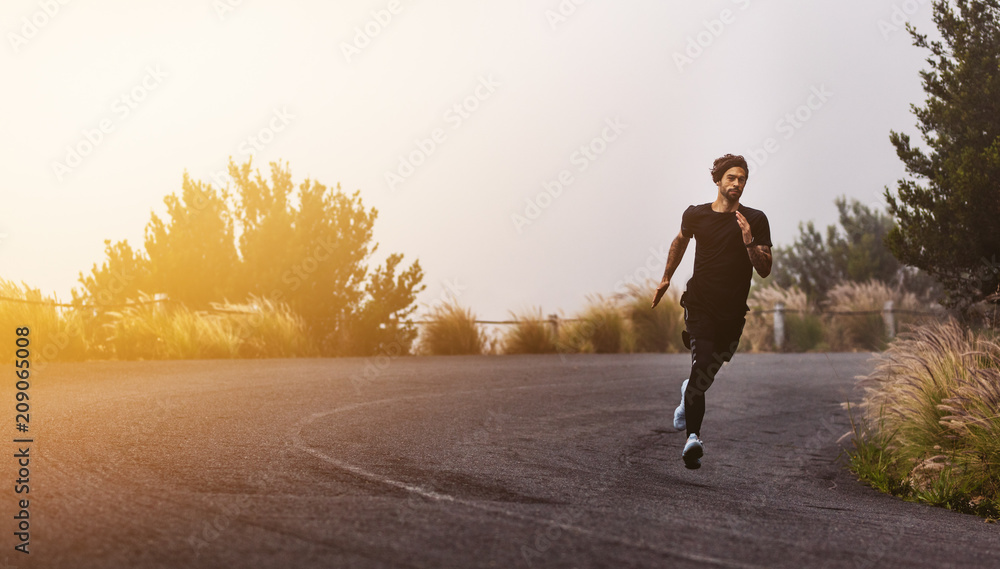 Athlete running on mountain road