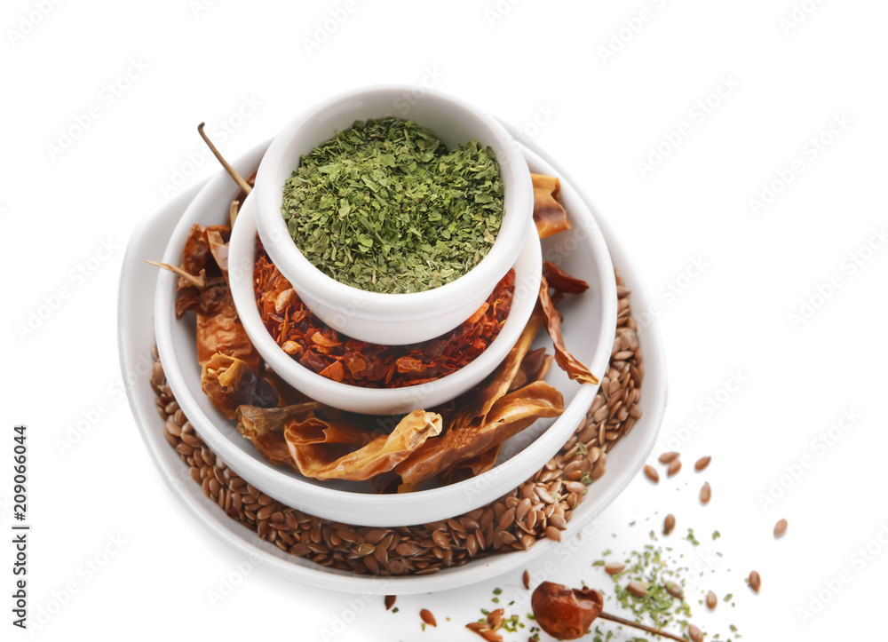 Bowls with different spices on white background