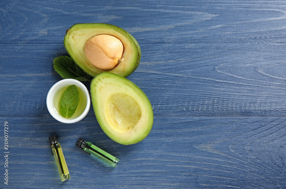 Avocado with ingredients for natural homemade cosmetics on wooden background