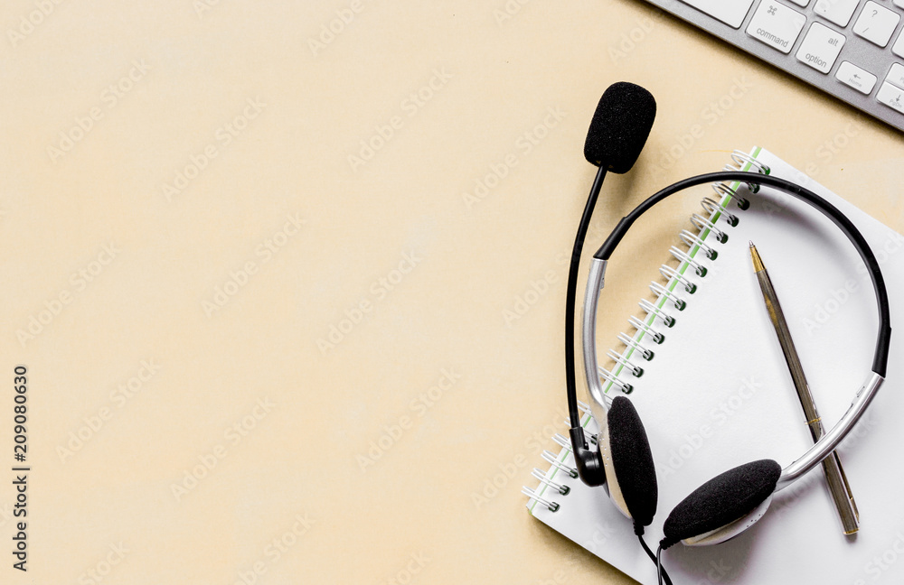 headset and keyboard on workdesk for call center concept top vie