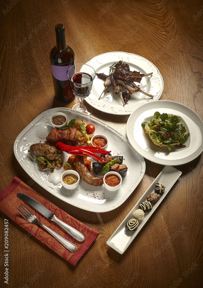 Snacks with red wine on the holiday table. A sumptuous table of food and alcohol.