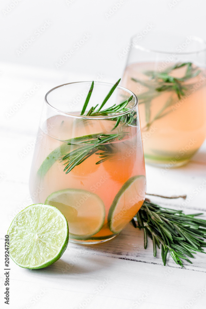 healthy morning with fresh drink, lime and rosemary on white tab