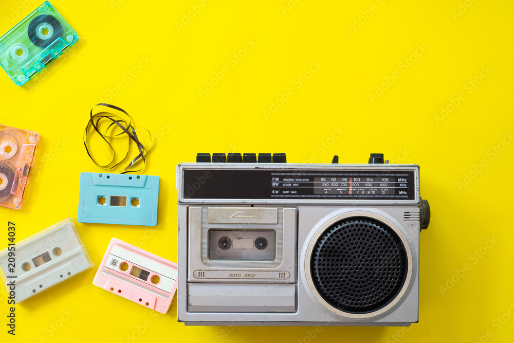 vintage radio and cassette player on yellow background, flat lay, top view. retro technology