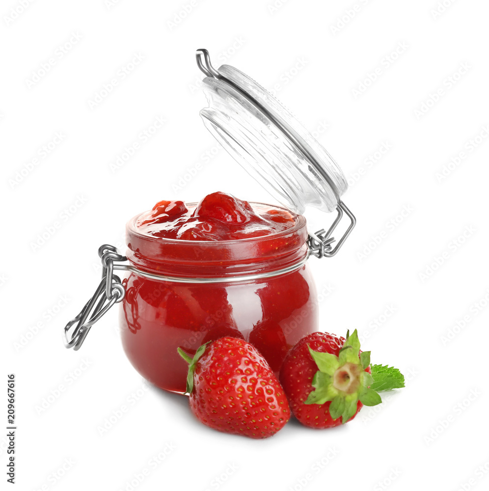 Glass jar with tasty strawberry jam on white background