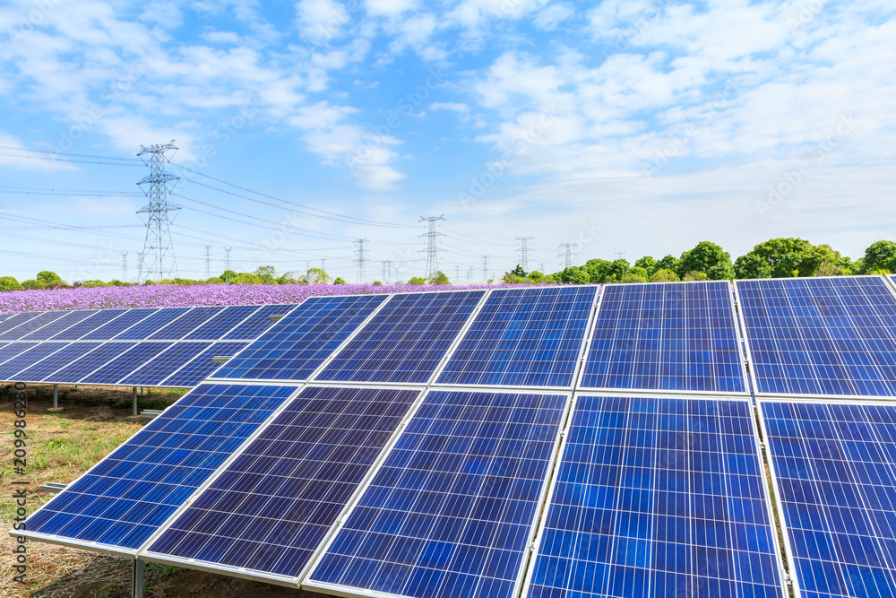 Solar panels and blue sky with white clouds