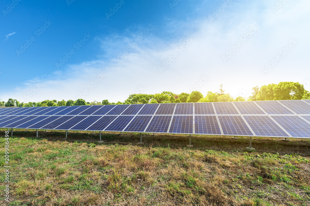 Solar panels and blue sky with white clouds